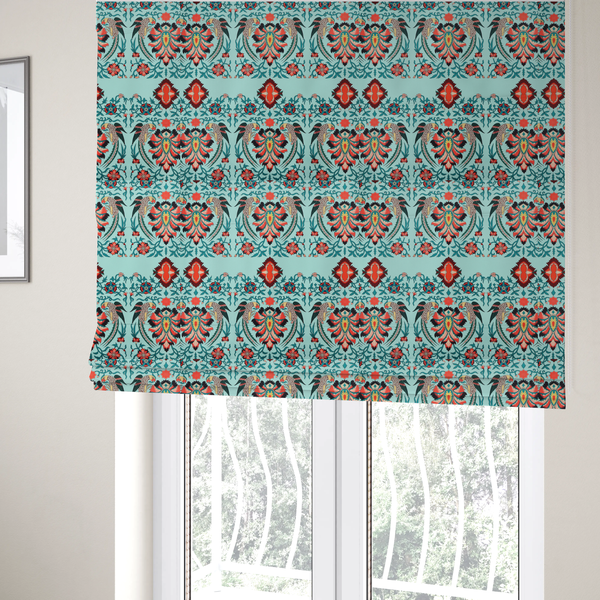 The fabric used to create these Roman blinds is a fabric features an intricate, symmetrical folk-art inspired pattern set against a soft, light turquoise background. The design showcases stylized birds facing toward central, ornate floral bursts, rendered in a bold colour palette of vibrant red, deep orange, teal, and charcoal.