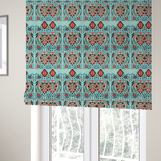 The fabric used to create these Roman blinds is a fabric features an intricate, symmetrical folk-art inspired pattern set against a soft, light turquoise background. The design showcases stylized birds facing toward central, ornate floral bursts, rendered in a bold colour palette of vibrant red, deep orange, teal, and charcoal.