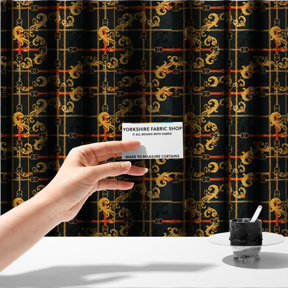 The fabric used to create these made-to-measure curtains is a luxury fashion fabric pattern featuring gold baroque acanthus scrolls layered over a grid of interlocking gold chains and red-orange leather straps on a black background.