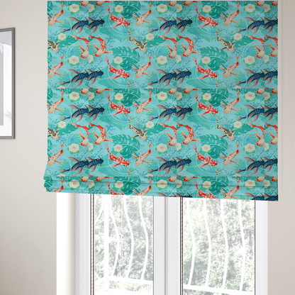 The fabric used to create these Roman blinds is a patterned fabric featuring vibrant orange, white, and dark blue koi fish swimming among lush tropical monstera leaves, water ripples, and white flowers on a light teal background.