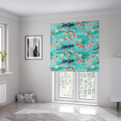 The fabric used to create these Roman blinds is a patterned fabric featuring vibrant orange, white, and dark blue koi fish swimming among lush tropical monstera leaves, water ripples, and white flowers on a light teal background.