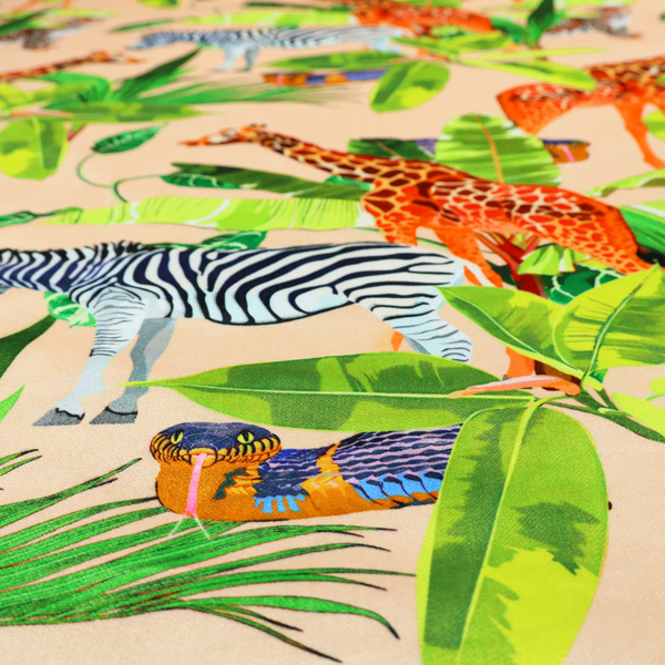 Patterned fabric featuring a vibrant safari scene with giraffes, zebras, leopards, and snakes nestled among lush tropical palm leaves on a soft beige background.