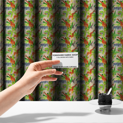 The fabric used to create these made-to-measure curtains is a patterned fabric featuring a vibrant safari scene with giraffes, zebras, leopards, and snakes nestled among lush tropical palm leaves on a soft beige background.