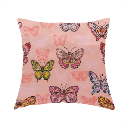 The fabric used to create this handmade cushion is a patterned fabric featuring a whimsical, repeating design of colourful butterflies in various patterns and shades—including orange, teal, pink, and yellow—scattered among faint, outline-style butterfly silhouettes on a soft, dusty pink background.