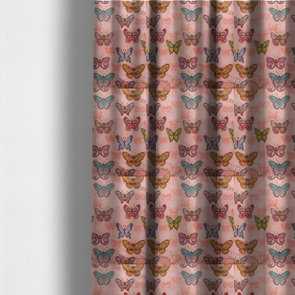 The fabric used to create these made-to-measure curtains is a patterned fabric featuring a whimsical, repeating design of colourful butterflies in various patterns and shades—including orange, teal, pink, and yellow—scattered among faint, outline-style butterfly silhouettes on a soft, dusty pink background.