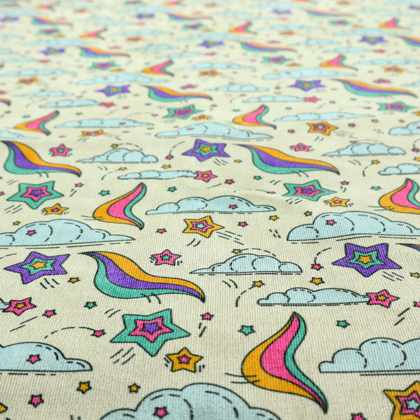 A whimsical, repeating fabric pattern featuring illustrated clouds, colourful shooting stars, and twinkling stars on a light cream background.