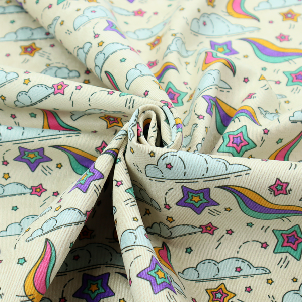 A whimsical, repeating fabric pattern featuring illustrated clouds, colourful shooting stars, and twinkling stars on a light cream background.
