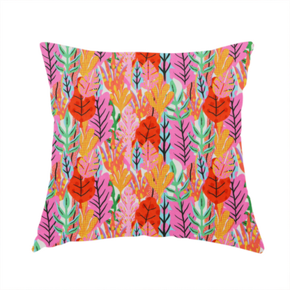 The fabric used to create this handmade cushion is a vibrant, repeating textile pattern featuring a dense arrangement of stylized tropical leaves in saturated shades of pink, orange, yellow, and bright green against a white background.