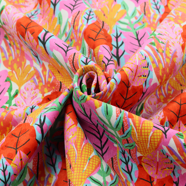 A vibrant, repeating textile pattern featuring a dense arrangement of stylized tropical leaves in saturated shades of pink, orange, yellow, and bright green against a white background.