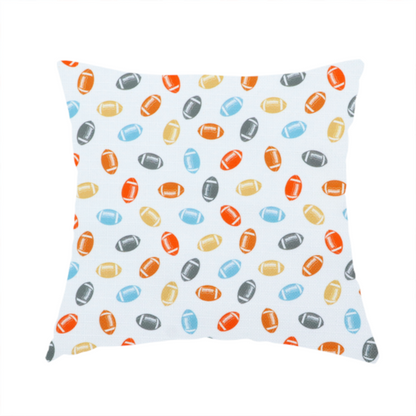 The fabric used to create this handmade cushion is a white fabric featuring a playful, repeating pattern of small American footballs.