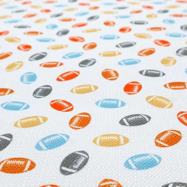 A white fabric featuring a playful, repeating pattern of small American footballs.