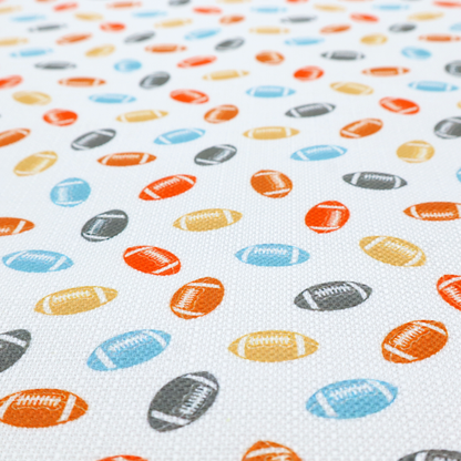 A white fabric featuring a playful, repeating pattern of small American footballs.