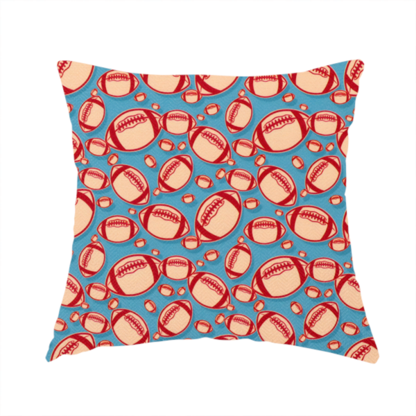 The fabric used to create this handmade cushion is a vibrant blue fabric featuring a dense, repeating pattern of American footballs.