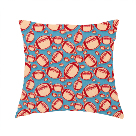 The fabric used to create this handmade cushion is a vibrant blue fabric featuring a dense, repeating pattern of American footballs.