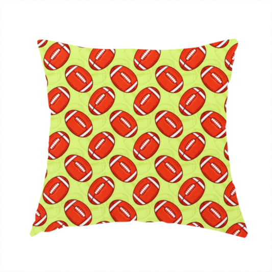 The fabric used to create this handmade cushion is a  vibrant lime green fabric featuring an orderly, repeating pattern of American footballs.