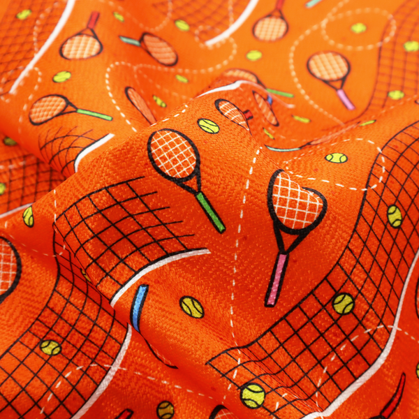 a vibrant burnt orange fabric featuring a dynamic, repeating tennis-themed pattern.