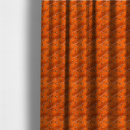 The fabric used to create these made-to-measure curtains is a vibrant burnt orange fabric featuring a dynamic, repeating tennis-themed pattern.