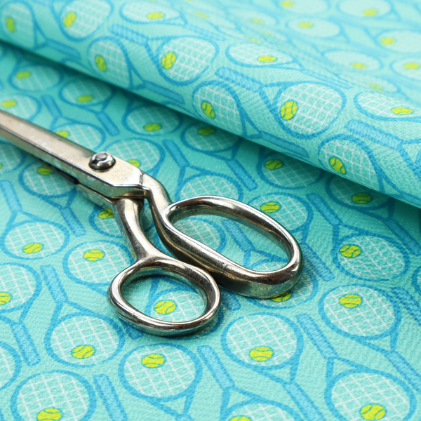 A bright turquoise fabric featuring a structured, repeating tennis pattern.