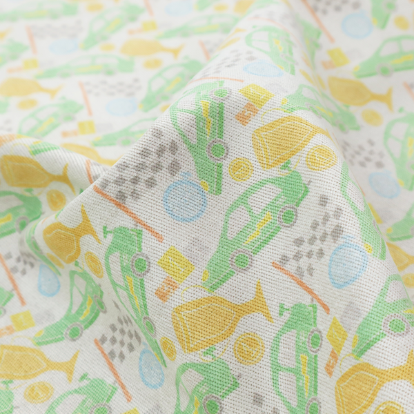 A soft white fabric featuring a charming, repeating racing-themed pattern in a pastel colour palette.