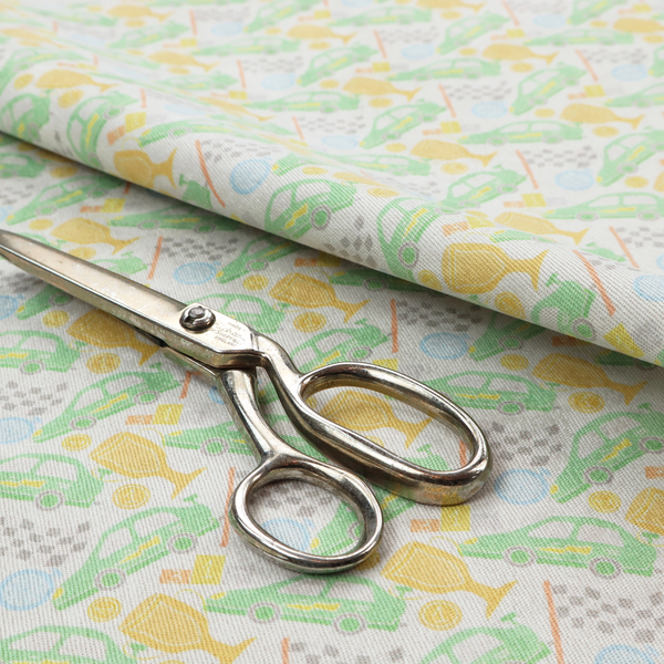 A soft white fabric featuring a charming, repeating racing-themed pattern in a pastel colour palette.