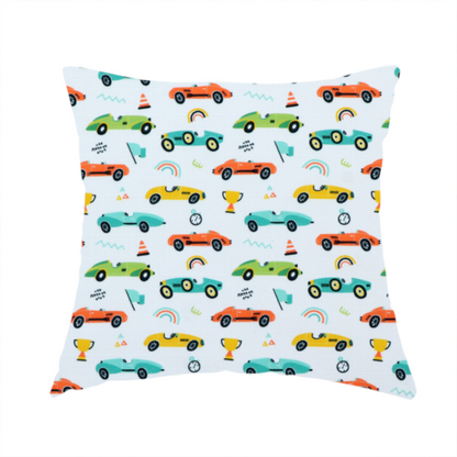 The fabric used to create this handmade cushion is a fabric featuring a whimsical, repeating pattern of vintage-style racing cars and track accessories.