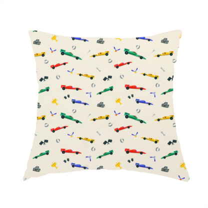 The fabric used to create this handmade cushion cream-coloured fabric featuring a detailed, repeating pattern of Formula 1-style racing cars and track elements.