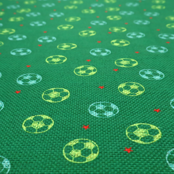 a rich emerald green fabric featuring a playful, repeating soccer and stars pattern.