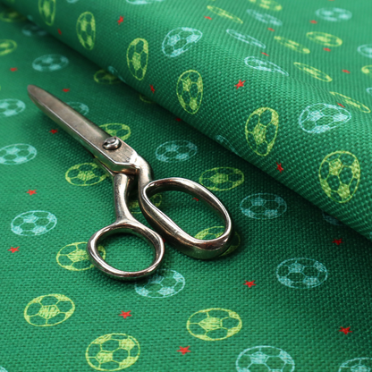 a rich emerald green fabric featuring a playful, repeating soccer and stars pattern.