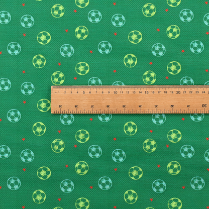 a rich emerald green fabric featuring a playful, repeating soccer and stars pattern.