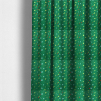 The fabric used to create these made-to-measure curtains are rich emerald green fabric featuring a playful, repeating soccer and stars pattern.