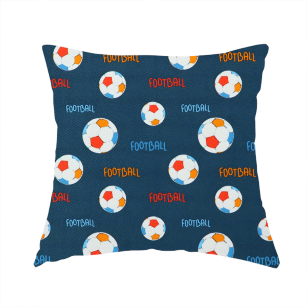 The fabric used to create this handmade cushion is a deep navy blue fabric featuring a lively, repeating soccer-themed pattern.