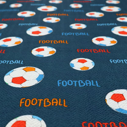 A deep navy blue fabric featuring a lively, repeating soccer-themed pattern.