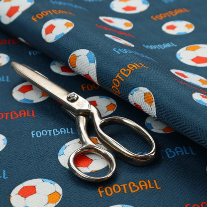 A deep navy blue fabric featuring a lively, repeating soccer-themed pattern.