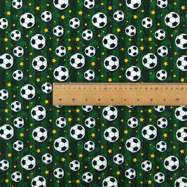 A rich forest green fabric featuring a classic, high-energy soccer and stars pattern.