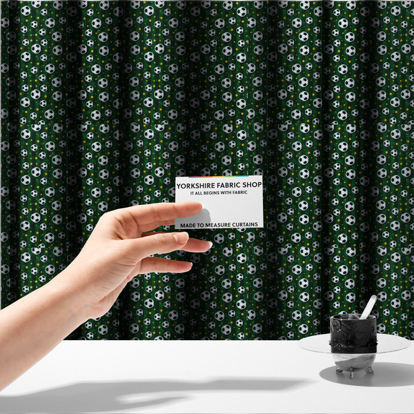The fabric used to create these made-to-measure curtains is a rich forest green fabric featuring a classic, high-energy soccer and stars pattern.
