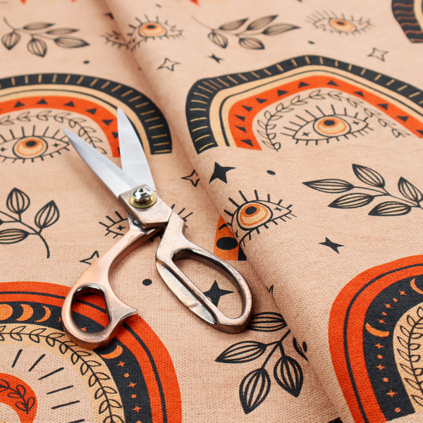 Seamless fabric pattern featuring bohemian style rainbows, mystic evil eyes, moon phases, and botanical leaves in terracotta orange, charcoal black, and tan.