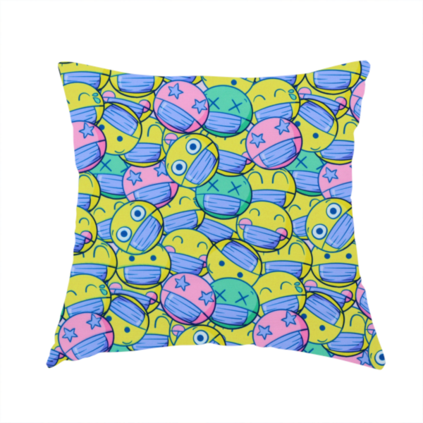 The fabric used to create this handmade cushion is a seamless novelty fabric pattern featuring a dense, overlapping collage of cartoon emoji smiley faces wearing blue face masks in bright neon yellow, green, and pink.