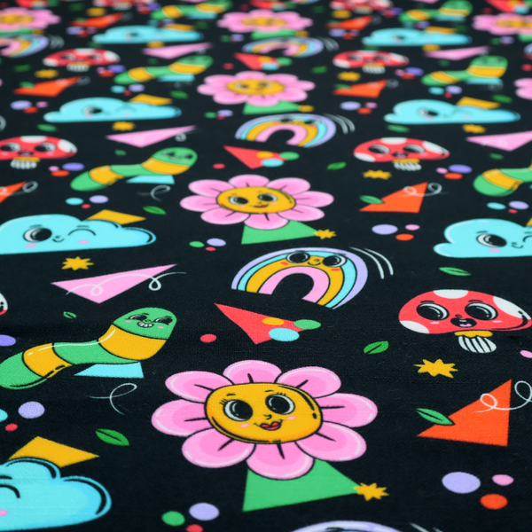 Seamless black fabric pattern featuring a colourful psychedelic print of retro cartoon mushrooms, smiling flowers, happy worms, winking clouds, and rainbow arches.