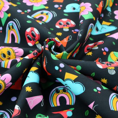 Seamless black fabric pattern featuring a colourful psychedelic print of retro cartoon mushrooms, smiling flowers, happy worms, winking clouds, and rainbow arches.