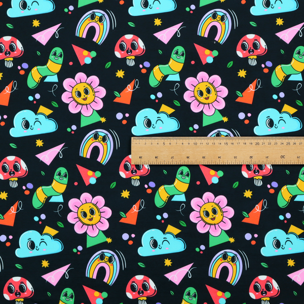 Seamless black fabric pattern featuring a colourful psychedelic print of retro cartoon mushrooms, smiling flowers, happy worms, winking clouds, and rainbow arches.