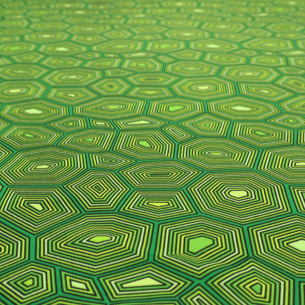 Seamless green fabric pattern featuring a detailed geometric print resembling a natural tortoise or sea turtle shell with concentric lines.