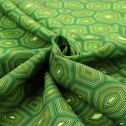 Seamless green fabric pattern featuring a detailed geometric print resembling a natural tortoise or sea turtle shell with concentric lines.