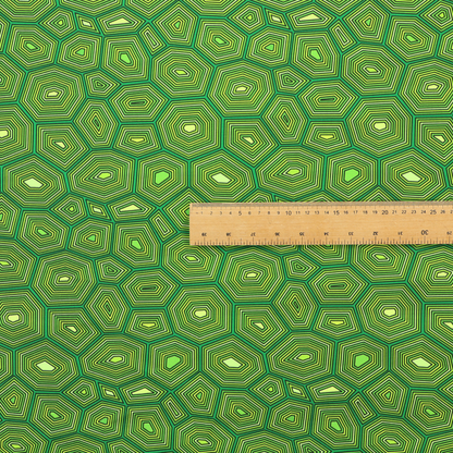 Seamless green fabric pattern featuring a detailed geometric print resembling a natural tortoise or sea turtle shell with concentric lines.
