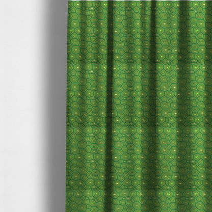 The fabric used to create these made-to-measure curtains is a seamless green fabric pattern featuring a detailed geometric print resembling a natural tortoise or sea turtle shell with concentric lines.