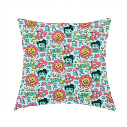 The fabric used to create this handmade cushion is a seamless light blue fabric pattern featuring a busy retro cartoon collage with smiling flowers, heart characters, pompadour men, and "WOW" comic speech bubbles.