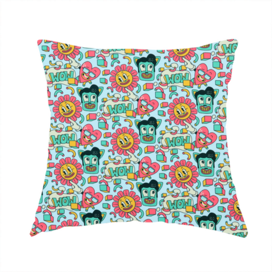 The fabric used to create this handmade cushion is a seamless light blue fabric pattern featuring a busy retro cartoon collage with smiling flowers, heart characters, pompadour men, and "WOW" comic speech bubbles.