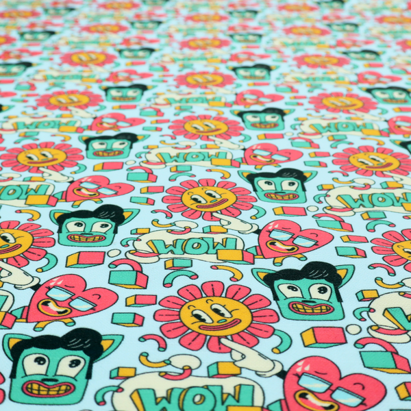Seamless light blue fabric pattern featuring a busy retro cartoon collage with smiling flowers, heart characters, pompadour men, and "WOW" comic speech bubbles.