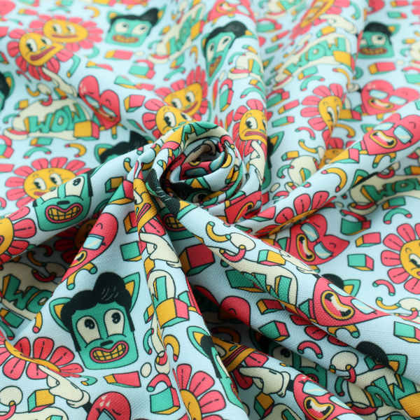 Seamless light blue fabric pattern featuring a busy retro cartoon collage with smiling flowers, heart characters, pompadour men, and "WOW" comic speech bubbles.