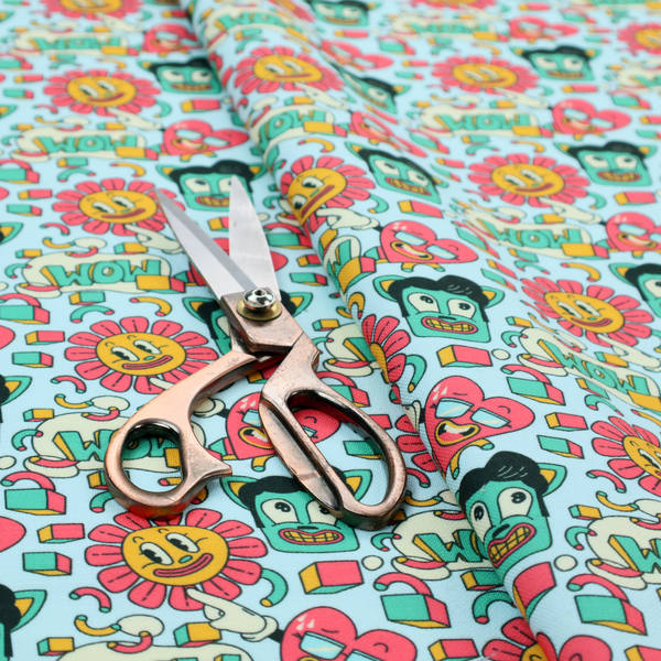 Seamless light blue fabric pattern featuring a busy retro cartoon collage with smiling flowers, heart characters, pompadour men, and "WOW" comic speech bubbles.