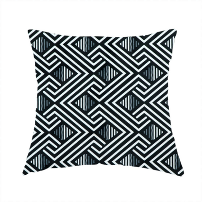 The fabric used to create this handmade cushion is a geometric pattern featuring a repeating labyrinthine or Greek key-inspired design. The fabric has a high-contrast black and white colour scheme, with white interlocking lines forming diamond shapes and diagonal pathways against a deep black background.